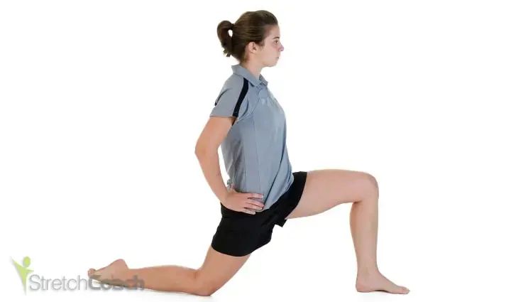 woman streching hip aductor forward with one knee on the ground and the other bent in front of her